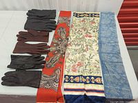 Overall lot view showing three scarves and three pairs gloves