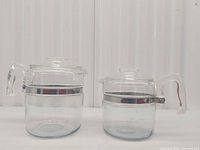 Both Pyrex glass pots side by side front view