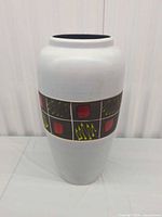 Full view of tall vase showing overall shape and decoration