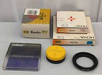 Group shot: boxed Hoya filters, Kenko Close-Up set, Cokin filter case, Kodak case, Asahi ring