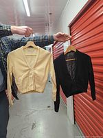 Both cardigans hung side by side showing color contrast and overall design