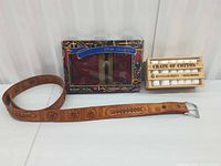 Overview showing belt, boxed wallet & pen set, crate of handkerchiefs