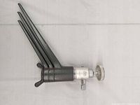 Tripod folded showing cast-metal legs and ball head