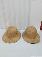 Two Brookstone straw safari hats top view