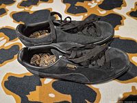 Side view of both sneakers showing suede uppers and laces