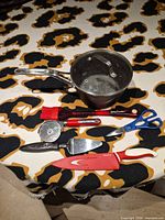 Overview of all utensils and saucepan on table