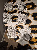 Six coiled white string light strands displayed on surface