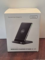 Front of sealed retail box showing wireless charger stand image and model WI-211