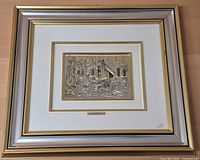 Framed artwork showing outer frame, mat and relief