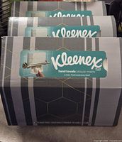 Front view of three sealed Kleenex hand towel boxes