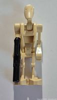 Front view of Battle Droid holding black blaster