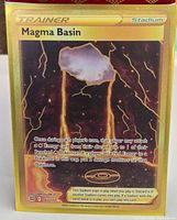Front of Magma Basin gold secret rare card in sleeve