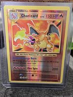 Card in toploader front view showing artwork, holo border and text