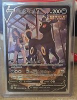 Umbreon V card in toploader front view