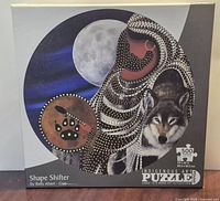Front of sealed puzzle box with artwork, title, piece count, round shape info
