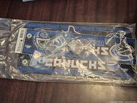Front view of sealed package showing license plate frame and keychains