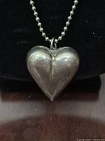 Close-up of sterling silver heart pendant showing shape and surface condition