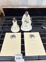 Both figurines and their pamphlets on stovetop