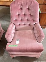 Front view showing tufted back, arms, skirted base, dimension tape visible