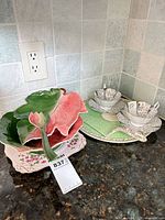 Overall lot showing leaf centerpiece bowl, two teacup and saucer sets, serving plate, pie server