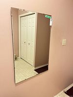 Front view of rectangular beveled mirror mounted on wall