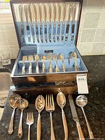 Open chest showing main flatware pieces and serving utensils laid out
