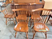 Front view of four side chairs and one armchair showing overall design and finish