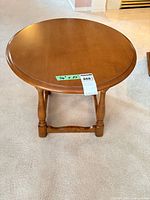 Full view of round end table, wood finish visible