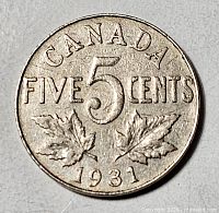 Reverse of 1931 Canada 5 cents coin showing denomination and maple leaves