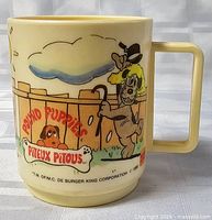 Front view showing Pound Puppies logo, dog holding cane, bilingual text, handle visible