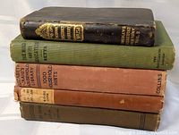 Stack of five books showing spines and bindings