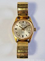Front view of Ermano gold-tone wristwatch with stretch band