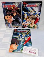 Three Gundam comic books laid out, showing covers
