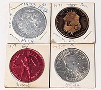 Obverse of four Mardi Gras doubloons in 2x2 cardboard holders