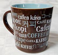 Brown Starbucks mug showing multilingual coffee text