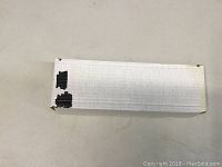 Closed white cardboard box containing the hockey trading cards, showing some minor wear and black marks on the end.