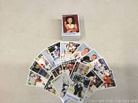 Cards spread out showing various players and team logos, front side visible.