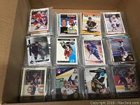 Box contents showing multiple stacks of assorted NHL hockey cards, close-ups of card faces featuring various players in action or portrait shots in NHL uniforms.