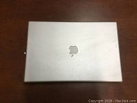 Closed Apple PowerBook G4 laptop showing aluminum top with Apple logo