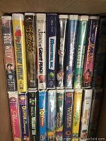 Photo of assorted VHS movie spines and front covers showing a mix of family and animated titles.