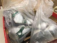 Pair of Liquid Force Alpha S wakeboard bindings wrapped in plastic inside original packaging.