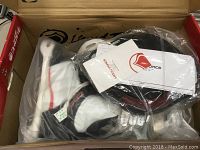 Photo showing the bindings still in original plastic bag within the box with tags visible.