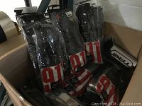 Box containing multiple sealed packages of Fox Racing 911 elbow guards, showing branding and packaging.