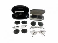 Group shot of six eyewear pairs including two in branded cases