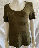 Front view of olive knit short sleeve shirt on mannequin