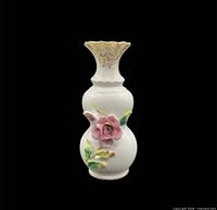 Front view of white porcelain bud vase with pink rose and scalloped rim