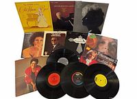 All twelve records arranged; eight album jackets and three loose vinyl discs visible