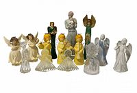 Group shot of 14 assorted angel figurines displaying materials, colours and relative sizes