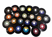Group layout of 22 vintage 45 RPM vinyl singles showing labels and condition