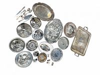 All 28 silver-plated pieces laid out, showing variety and overall condition